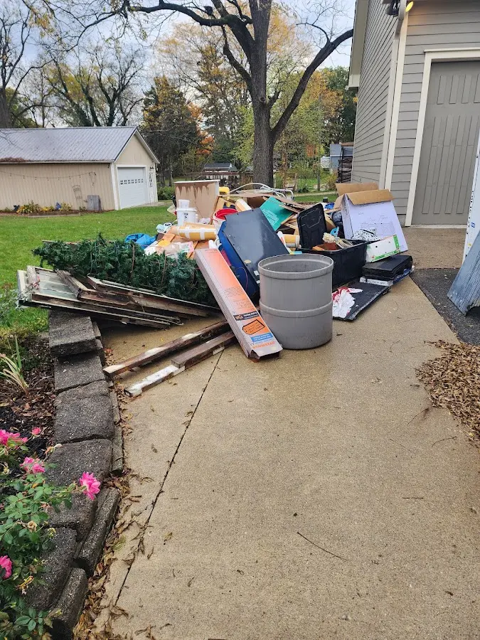 Dumpster being loaded with debris for Estate Cleanout Dumpster Rental in Ontelaunee